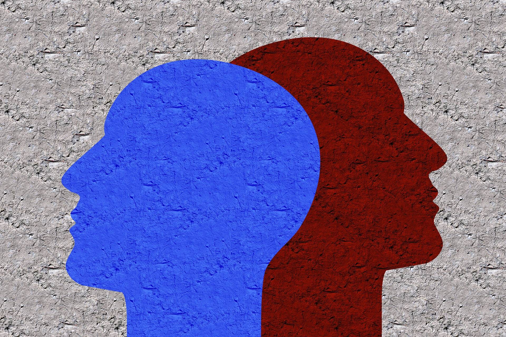 Illustration de deux visages en opposition, bleu et rouge - gestion des conflits